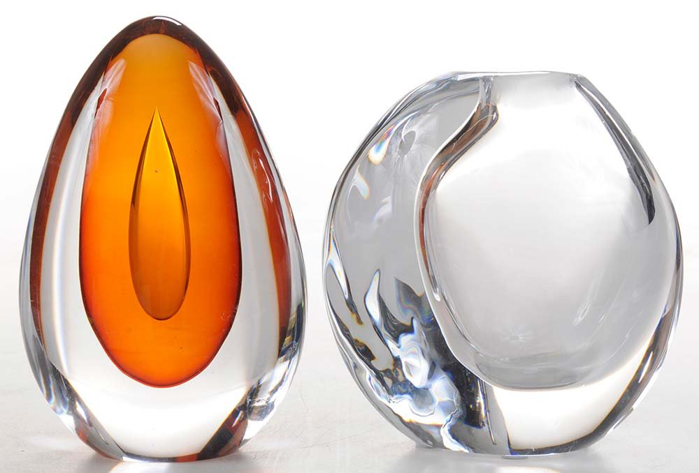 Two Kosta Boda Glass Sculptures: by Mona Morales Schildt and Goran Warff Sweden, 20th century, Schildt sculpture clear over amber with large teardrop, engraved "Kosta" on bottom with numbers, 6-3/4 in.; together with clear asymmetric