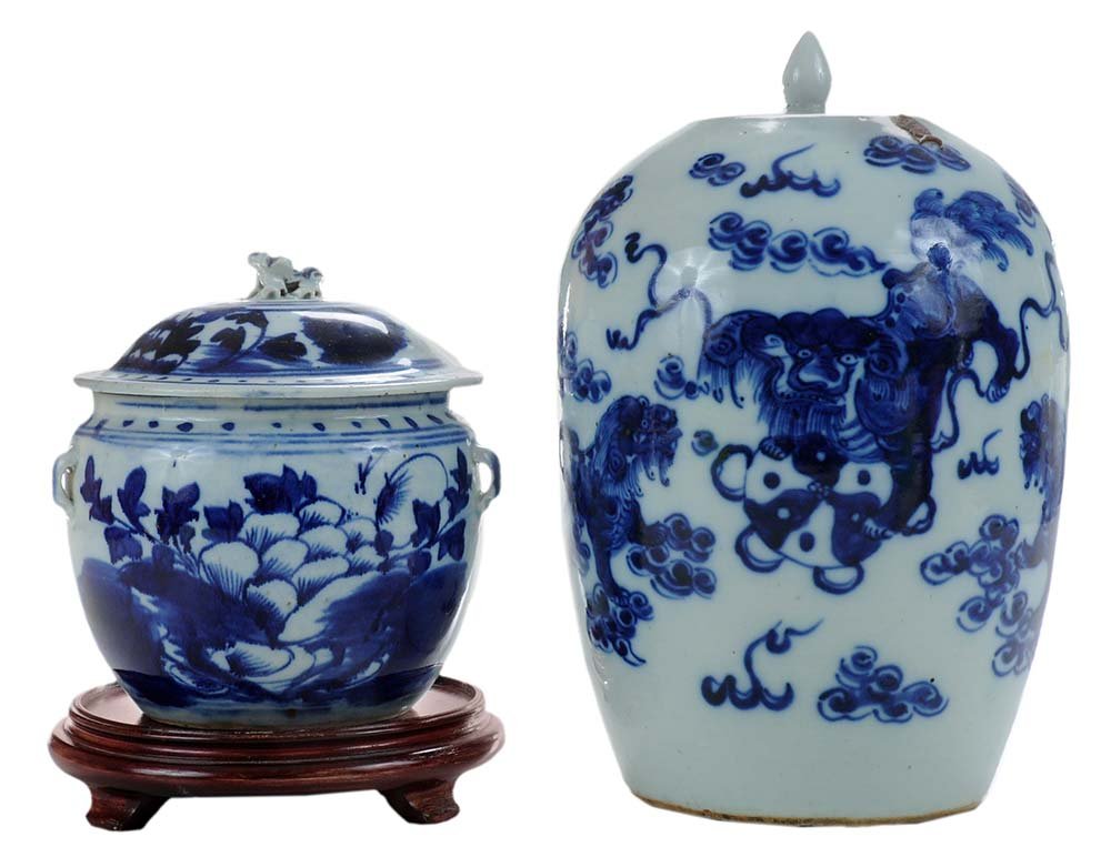 Two Chinese Porcelain Blue and White: Decorated Lidded Jars 19th/20th century, one with foo dog and cloud decoration in dark blue, modern wooden base, [very minor glaze flakes to rim and edges of lid;] with a koi-decorated example with fo