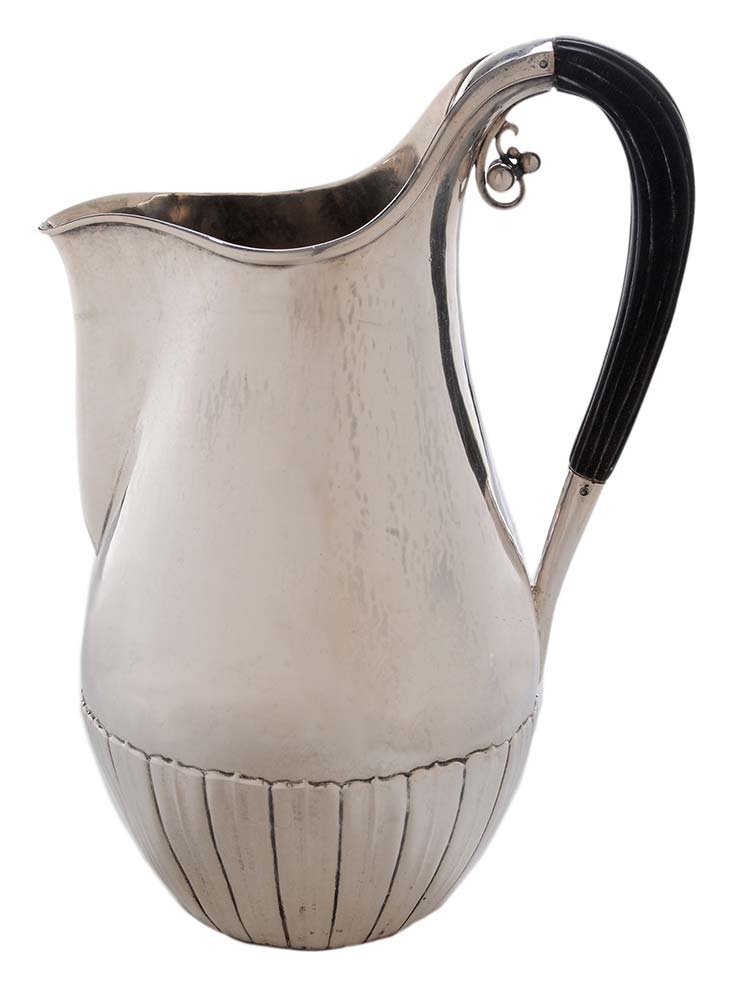 George Jensen Cosmos Sterling Pitcher: Denmark, 1925-1932, designed by Johan Rohde, baluster form body with fluted lower body, hammered finish, scroll and berry decoration at reeded wooden handle, marks for Georg Jensen, "45A", no monogram