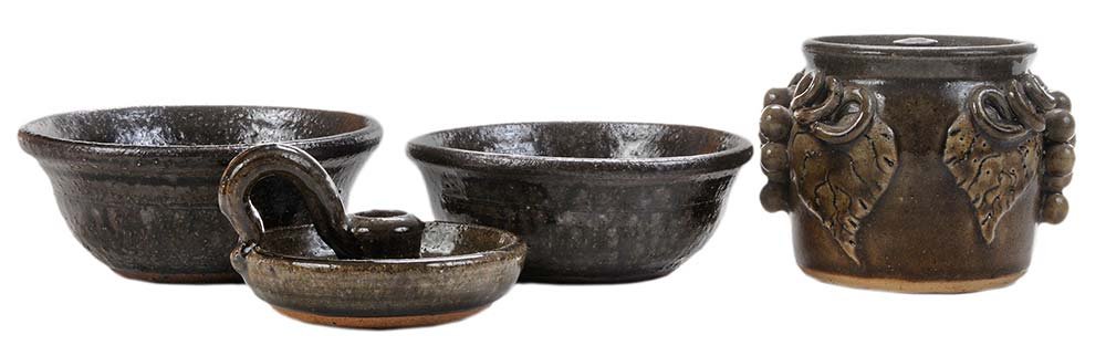Four Pieces of Lanier Meaders Pottery: (White County, Georgia, 1917-1998), all with dark green alkaline glaze: grapevine decorated lidded jar, 4-1/2 in., [undersized mismatched lid;] candleholder, 3 x 4-3/4 in., [firing crack on base]; two
