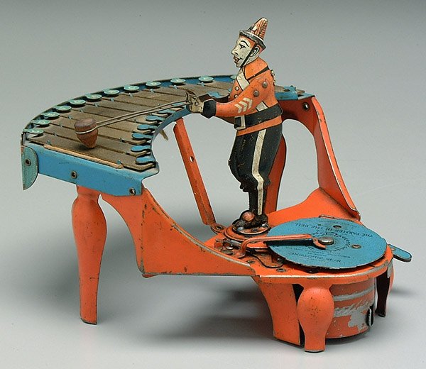 Zilotone wind-up toy,: Zilotone wind-up toy, clown playing xylophone, removable records (Farmer in the Dell on toy), partial working order, minor paint losses and wear at points of contact, 7-1/2 x 7-1/2 x 9"