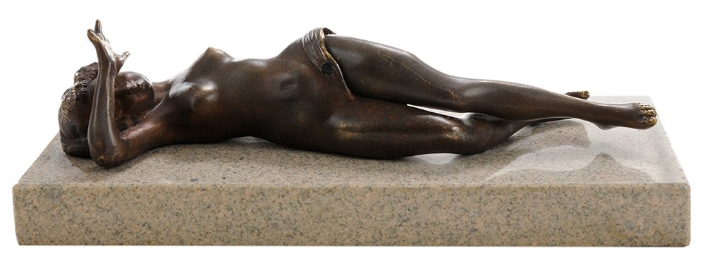 Naughty Nude Bronze Figural Cigar: Cutter probably 20th century, the reclining female figure with hands covering eyes, one leg raises revealing a circular cigar cutter, polished stone base, 2-3/4 x 8-3/4 x 3-7/8 in.. Condition: good wo