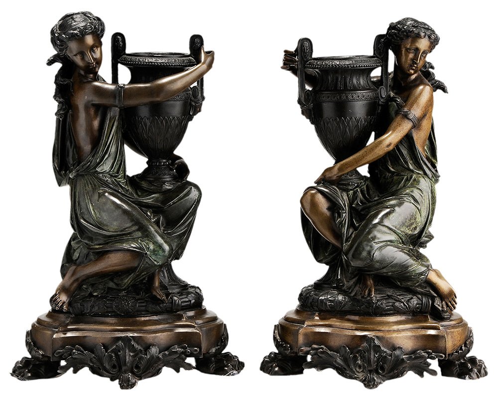 After Albert Ernest Carrier-Belleuse: (French, 1824-1887) Classical Figures of Vestals Holding Urns, a pair, a 20th century casting, signed "A. Carrier", patinated bronze on bronze footed plinths, 20 in.,. Condition: casting flaws. Notes: