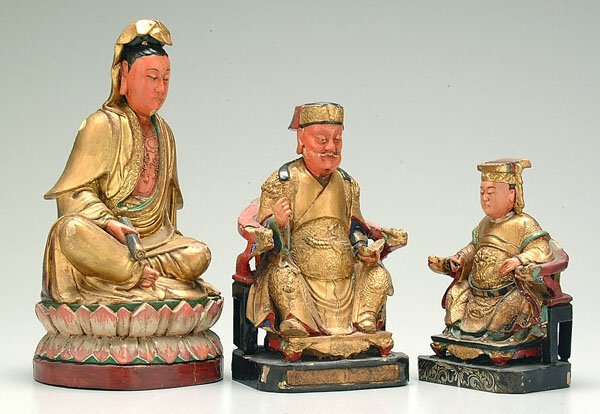 Three carved Oriental figures,