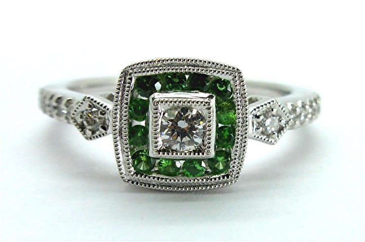 0.43ct Diamond and Tsavourite 14k White Gold Ring: This .43ct diamond and lime green Tsavourite 14k white gold ring containswith 15 channel and bead set round brilliant cut natural and genuine G SI1 quality diamonds with a weight of 0.23ct. In additio