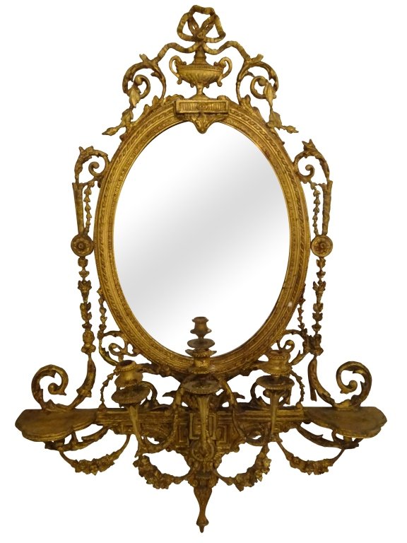 ENGLISH- GILTWOOD GIRANDOLE: Oval mirror with three light candelabrum with two flanking shelves. Measures 47 inches in height by 34 inches in width by 8 inches in depth.
