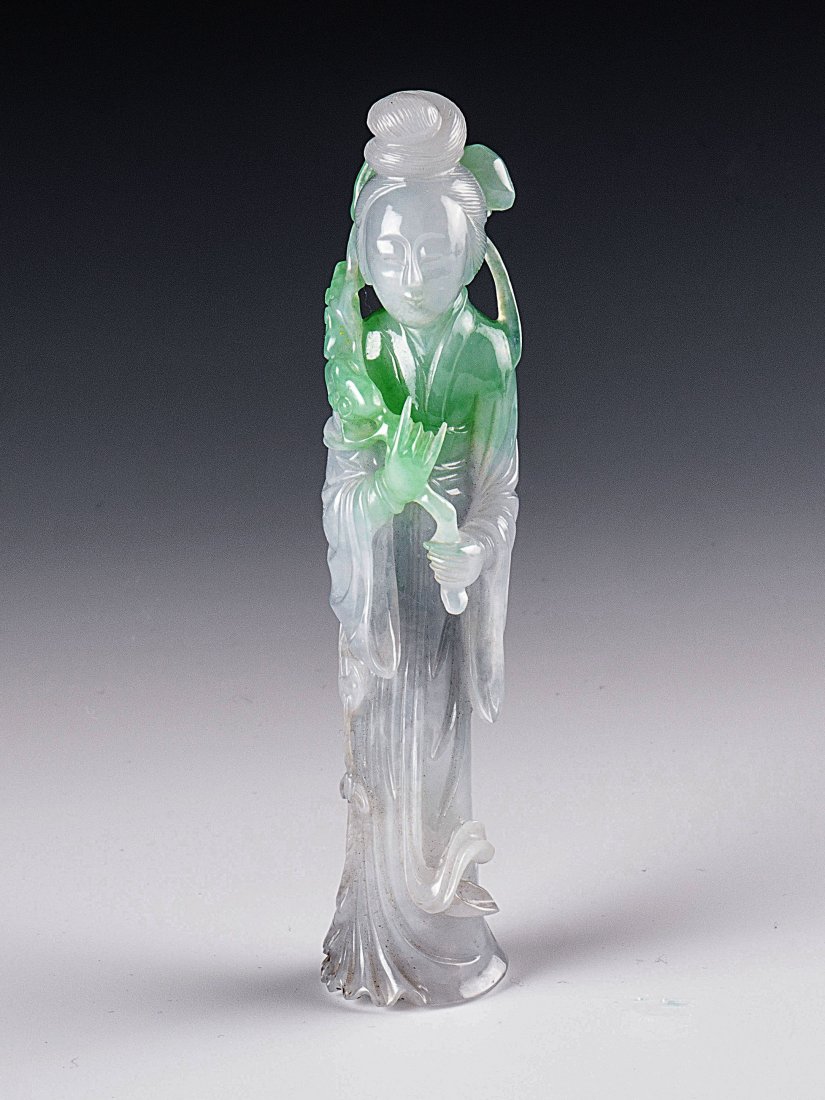 A carved Jadeite Figure of A Lady: A translucent apple green jadeite carving of standing lady, holding a Ruyi scepter against the shoulder.size:11CM H