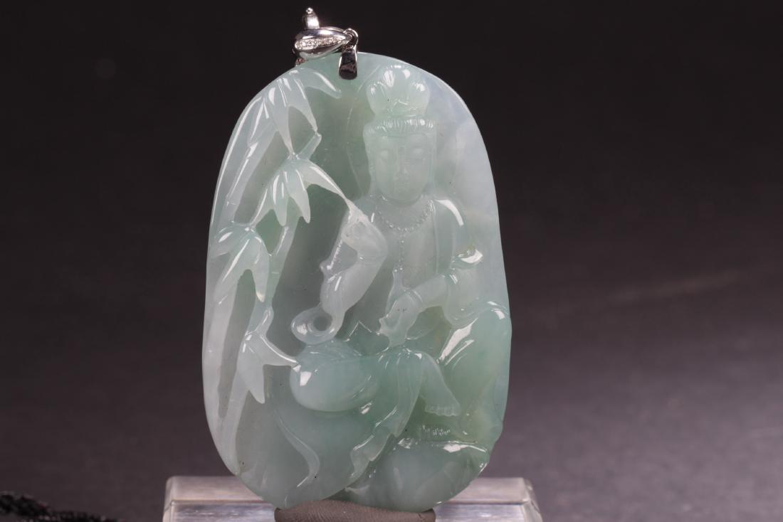 Chinese Jade Pendant: Chinese Jade Pendant, depicting a carved guanyin statue in sitting position, holding a vessel, with bamboo trees on the right.Comes attached with a black string. Height: 3"