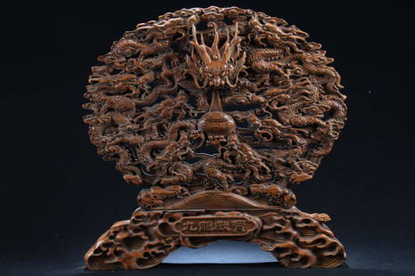 A Chinese Massive Wooden Dragon-decorating Fortune: A Chinese Massive Wooden Dragon-decorating Fortune Display . Height: 15.25 (inch). Width: 15.5 (inch).