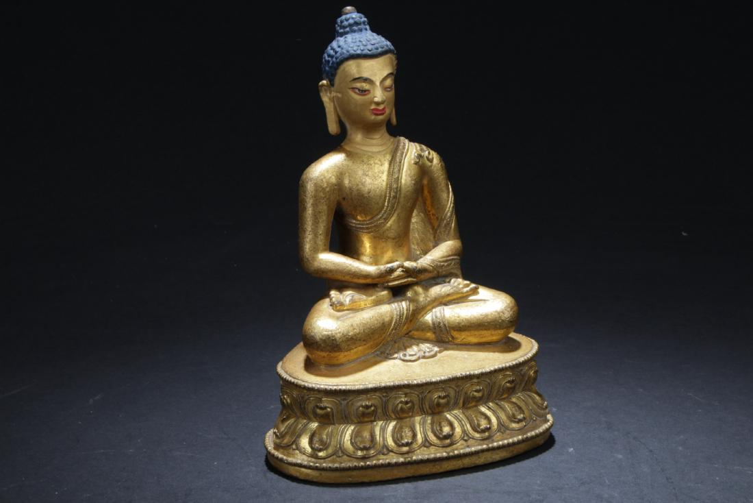 Antique Chinese Gilt Bronze Buddha Statue: Seated in dhyanasana on a lotus throne, the hands held in front of the lap, wearing long flowing robe, the face with a serene expression. Height: 6 "