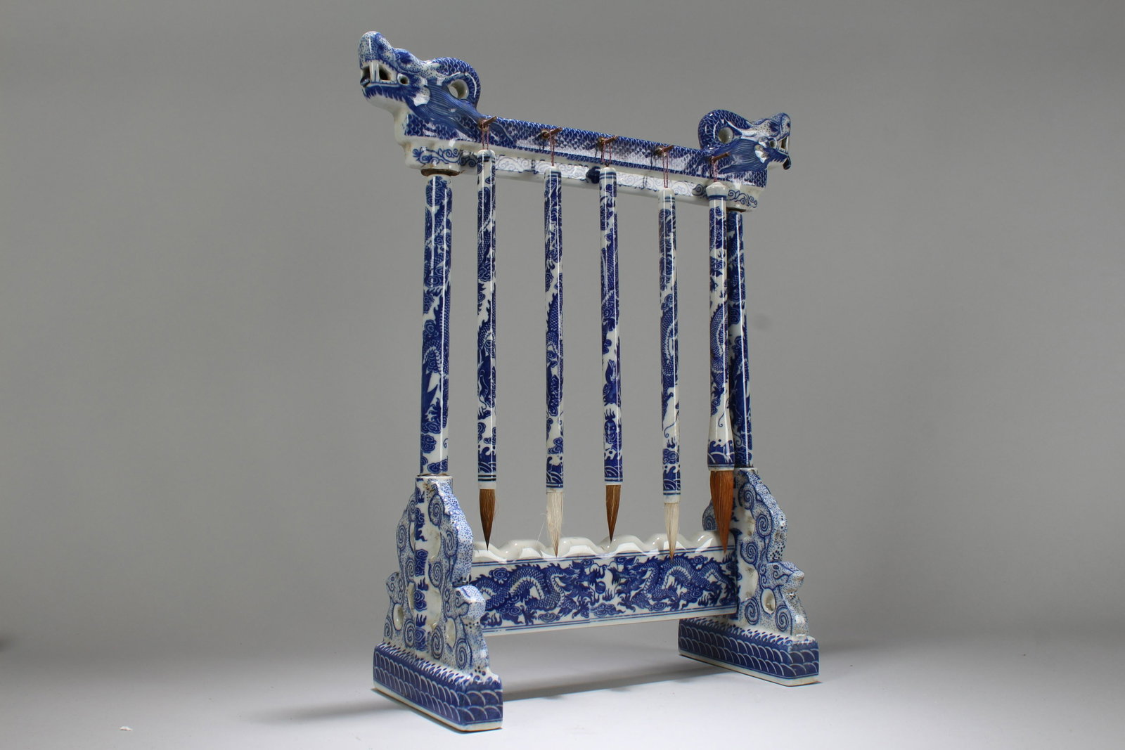 An Estate Chinese Blue and White Porcelain: An Estate Chinese Blue and White Porcelain Dragon-decorating Pen Holder. Height: 16.75 (inch). Length: 5.75 (inch). Width: 10.5 (inch).