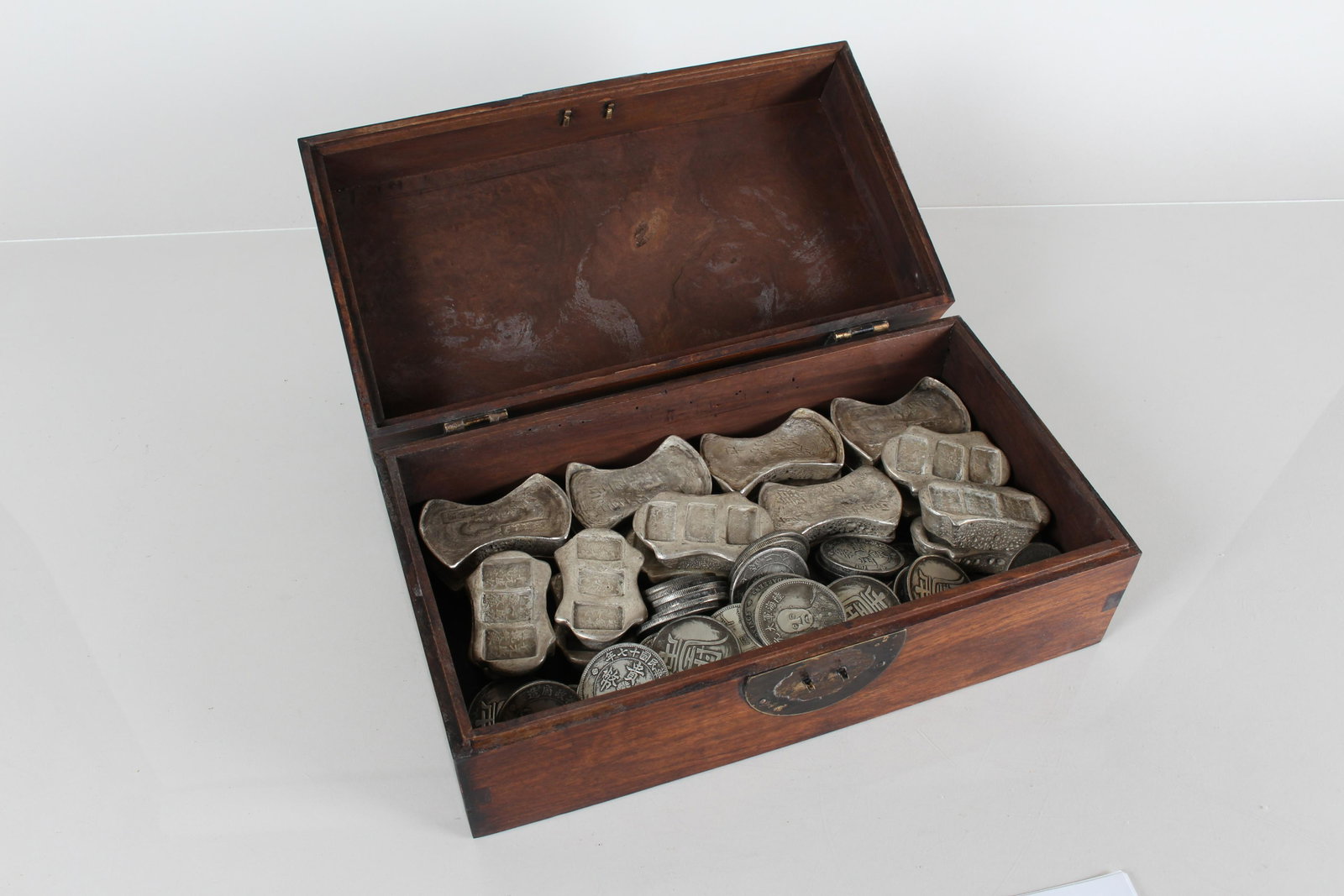 A Chinese Coin-filled Wooden Fortune Box: A Chinese Coin-filled Wooden Fortune Box. Height: 4 (inch). Length: 11.75 (inch). Width: 6.5 (inch).