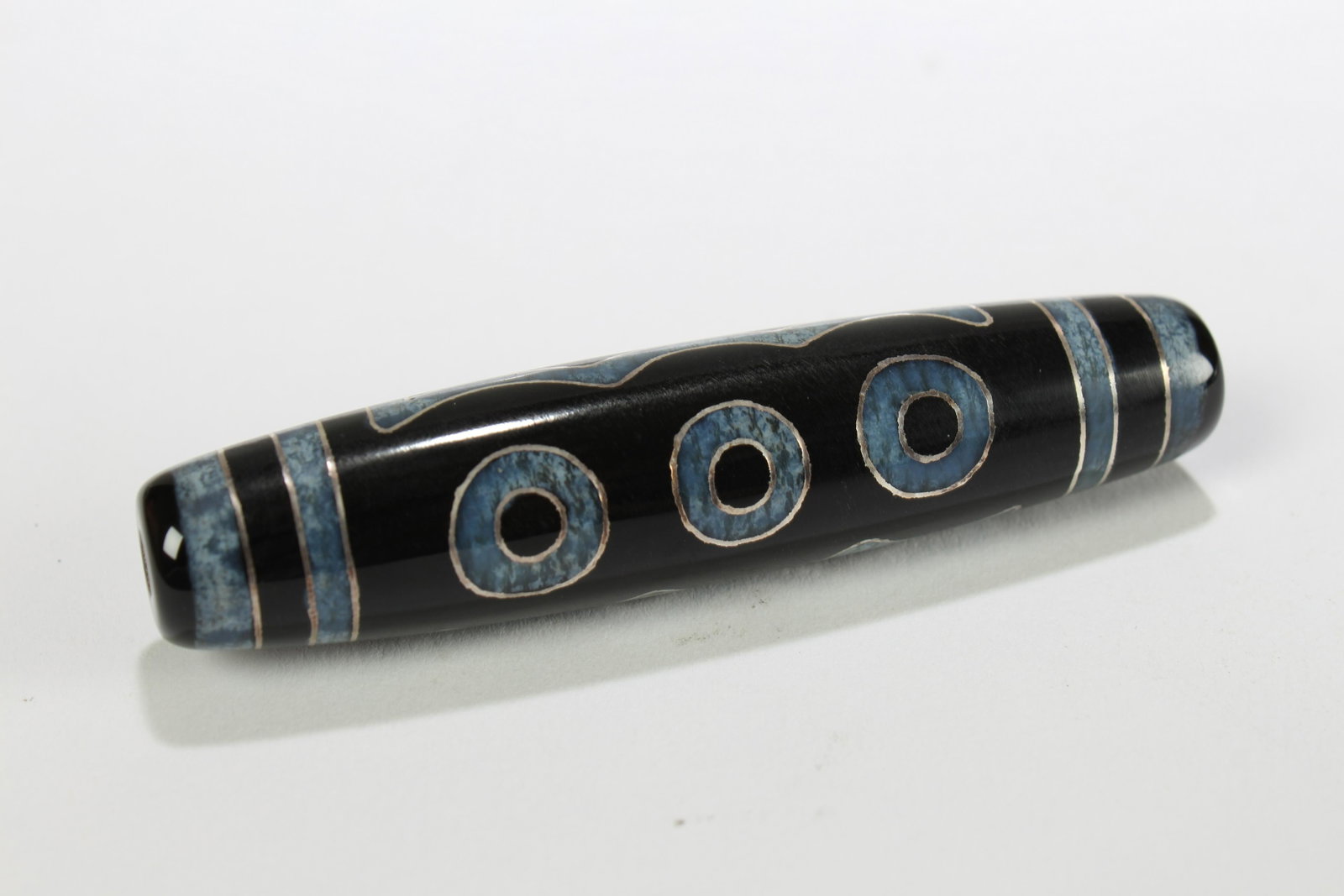 A Tibetan Religious Dzi Bead: A Tibetan Religious Dzi Bead . Length: 2.75 (inch).