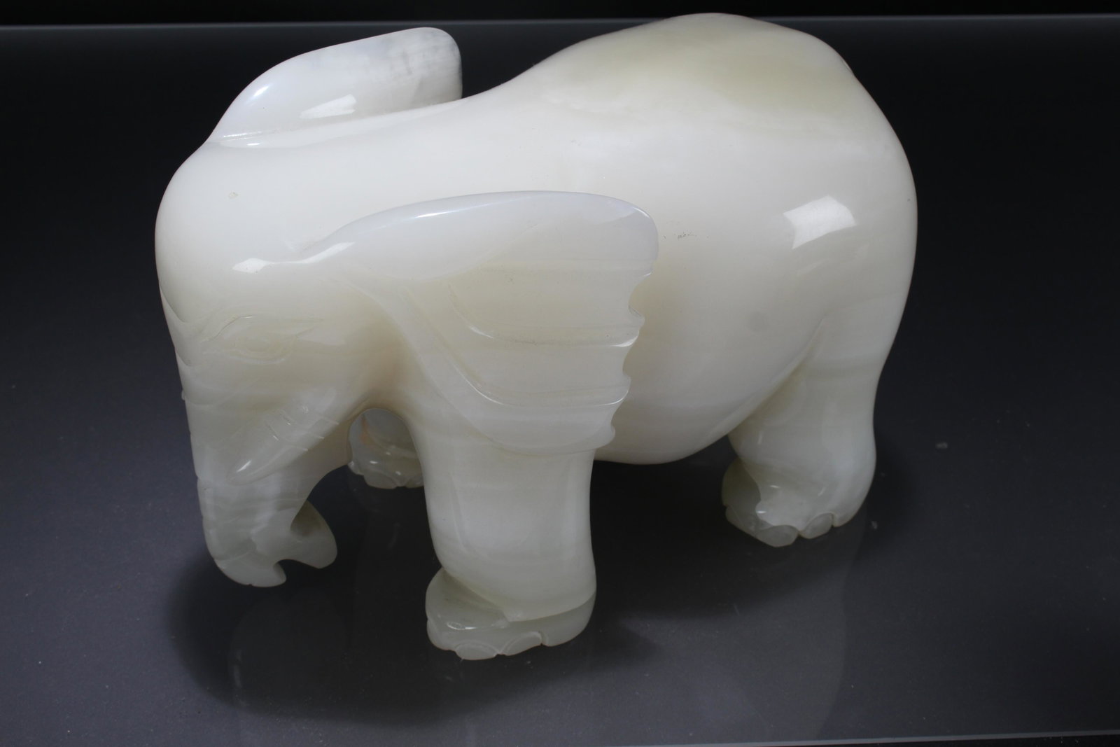 A Chinese Vividly-detailed Jade Elephant-portrait Fortune Statue: A Chinese Vividly-detailed Jade Elephant-portrait Fortune Statue . Height: 7.5 (inch). Length: 11 (inch). Width: 6 (inch).