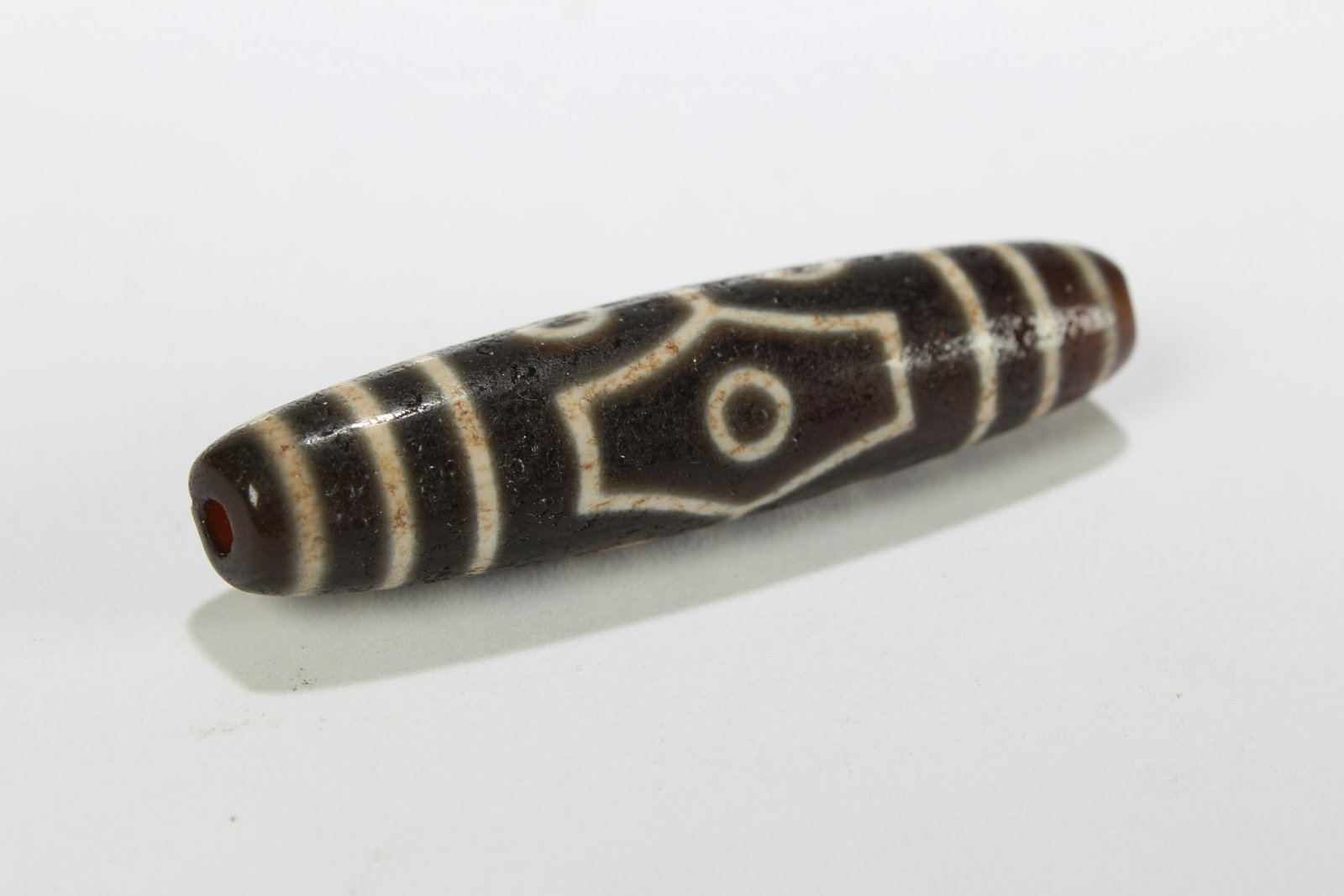 A Tibetan Religious Dzi Bead: A Tibetan Religious Dzi Bead . Length: 2.25 (inch).