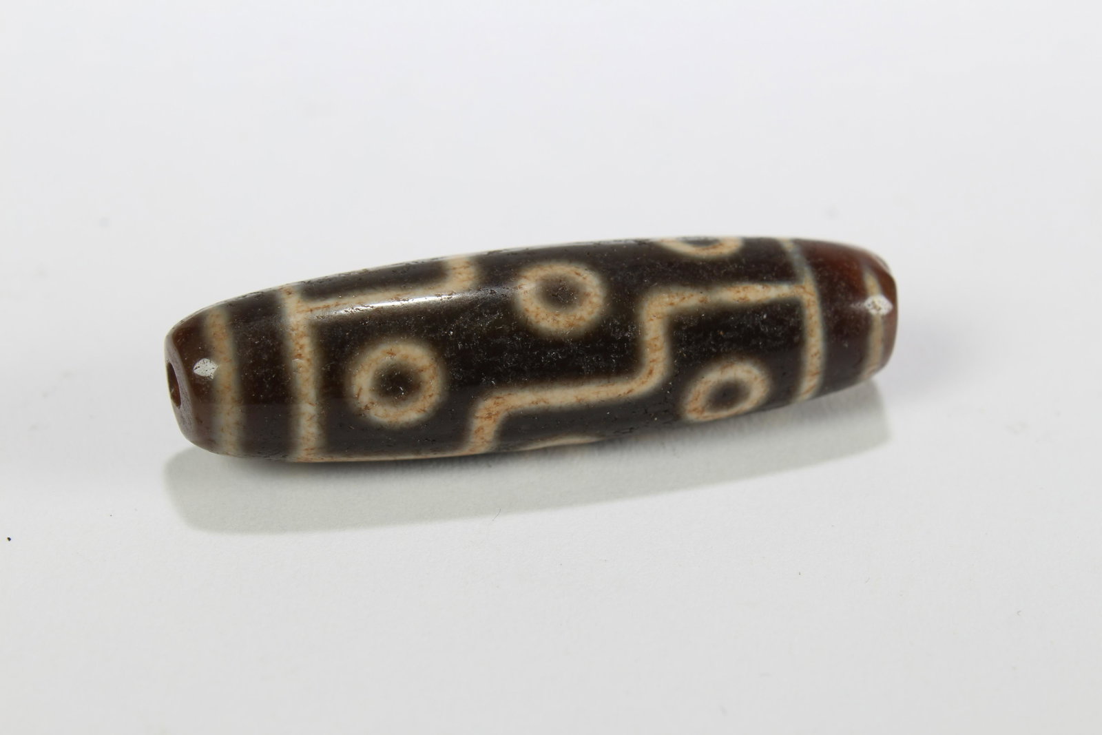 A Tibetan Religious Dzi Bead: A Tibetan Religious Dzi Bead . Length: 2 (inch).