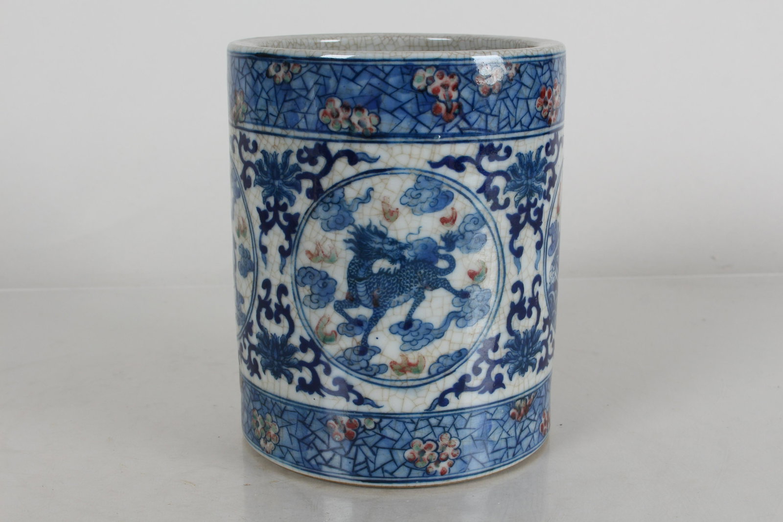 A Chinese Myth-beast Circular Blue and White Porcelain Brush Pot: A Chinese Myth-beast Circular Blue and White Porcelain Brush Pot. Height: 5.5 (inch).