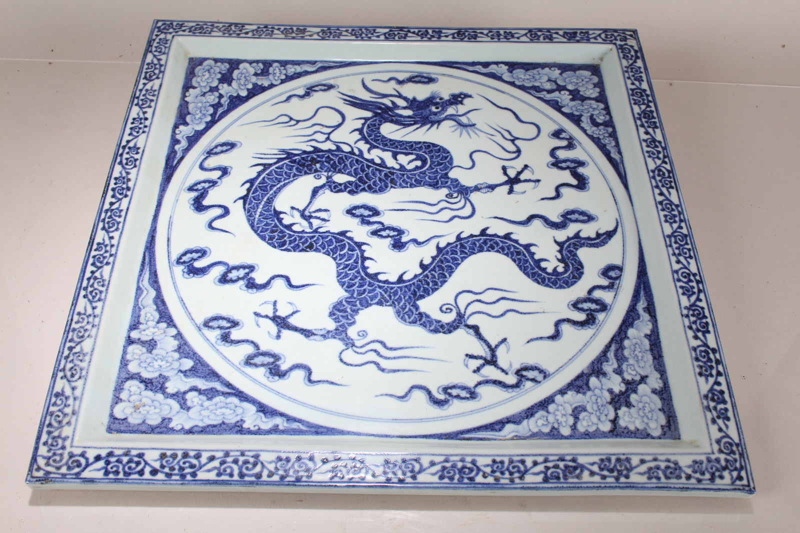 A Chinese Dragon-decorating Blue and White Square-based Porcelain Fortune Plate: A Chinese Dragon-decorating Blue and White Square-based Porcelain Fortune Plate. Length: 17 (inch). Width: 17 (inch).