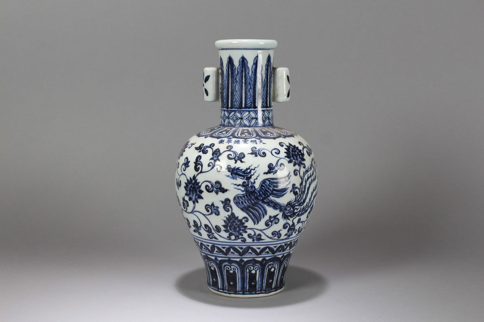 A Chinese Joyful-kid Porcelain Fortune Vase: A Chinese Blue-and-white Phoenix-decorating Porcelain Fortune Vase. Height: 11.5 (inch). Opening Diameter: 6 (inch)