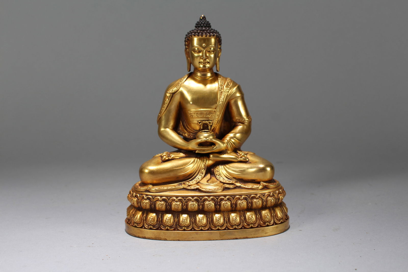A Chinese Gilt Vividly-detailed Religious Fortune Buddha Statue: A Chinese Gilt Vividly-detailed Religious Fortune Buddha Statue. Height: 6 (inch). Width: 4.5 (inch). Length: 3 (inch).