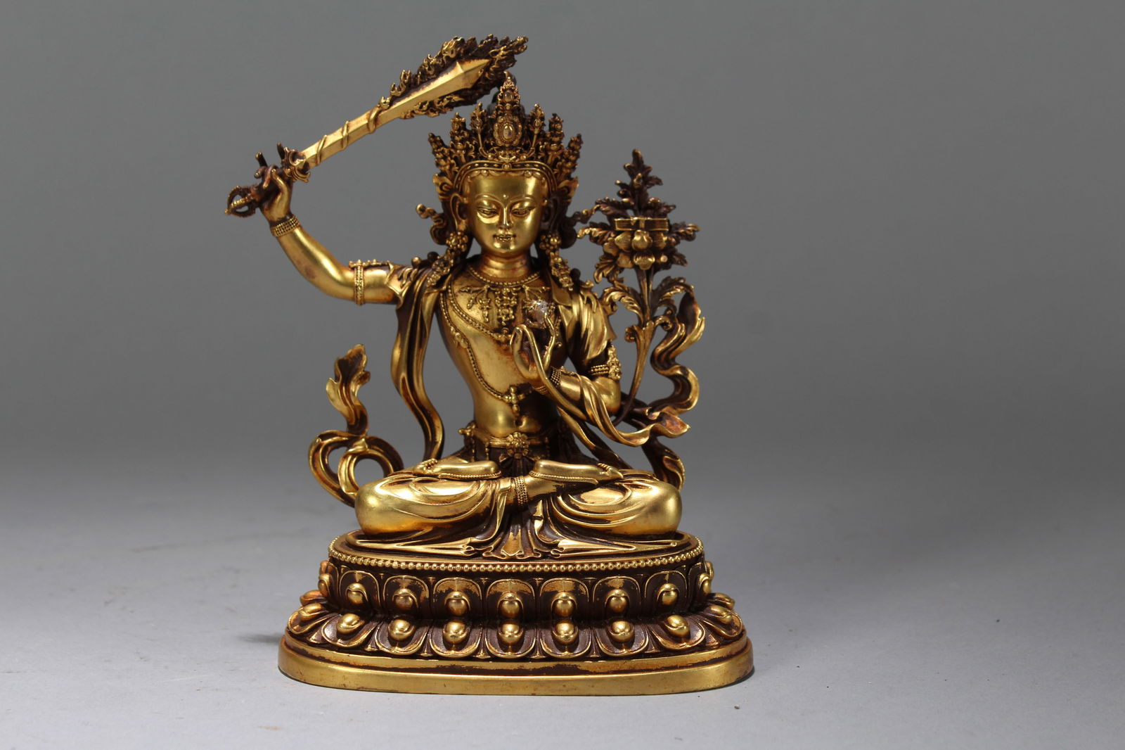 A Chinese Gilt Vividly-detailed Religious Fortune Buddha Statue: A Chinese Gilt Vividly-detailed Religious Fortune Buddha Statue. Height: 5.75 (inch). Width: 4.25 (inch). Length: 3 (inch).