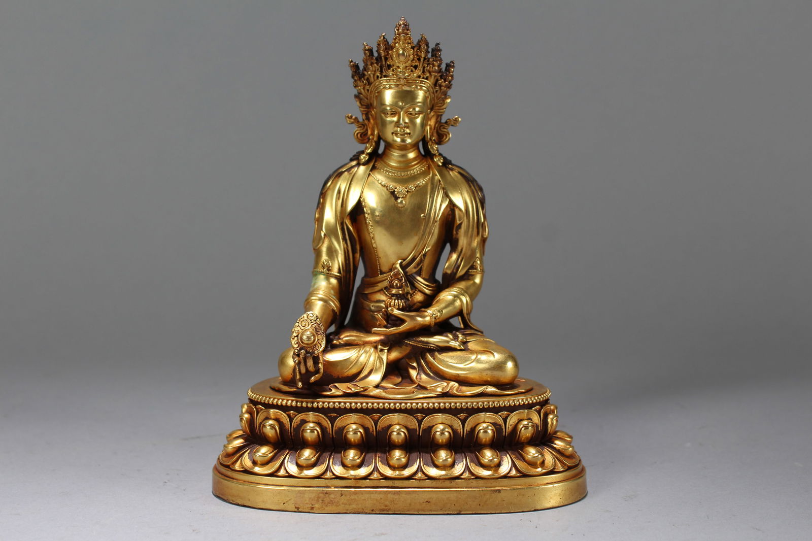 A Chinese Gilt Vividly-detailed Religious Fortune Buddha Statue: A Chinese Gilt Vividly-detailed Religious Fortune Buddha Statue. Height: 6.5 (inch). Width: 5 (inch). Length: 3.25 (inch).