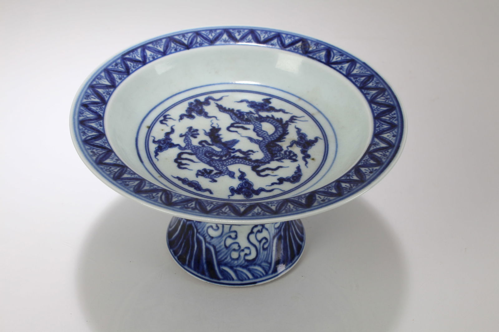 A Chinese Blue and White Dragon-decorating Porcelain Fortune Cup: A Chinese Blue and White Dragon-decorating Porcelain Fortune Cup. Height: 4.25 (inch). Opening Diameter: 8 (inch).