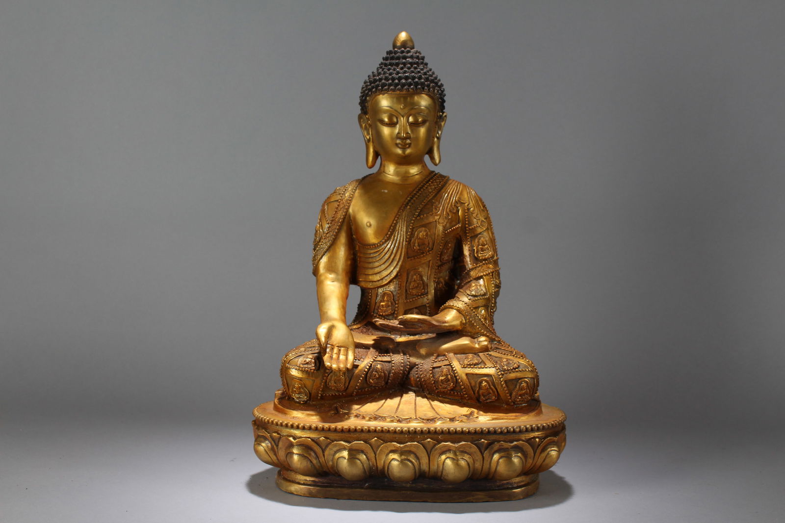 A Chinese Lotus-seated Gilt Religious Fortune Massive Buddha Statue: A Chinese Lotus-seated Gilt Religious Fortune Massive Buddha Statue. Height: 18 (inch). Width: 11.5 (inch). Length: 8 (inch).