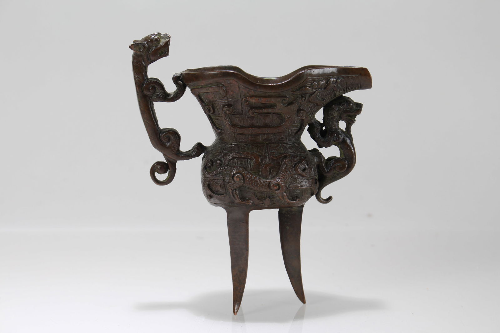 A Chinese Tri-podded Fortune Cup: A Chinese Tri-podded Fortune Cup. Height: 5.25 (inch). Length: 4.5 (inch).