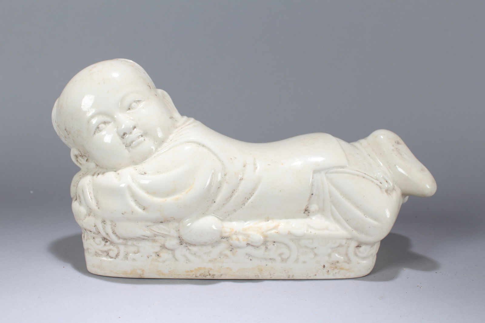 A Chinese Joyful-kid Porcelain Fortune Pillow Stand: A Chinese Joyful-kid Porcelain Fortune Pillow Stand. Height: 7 (inch). Width: 13 (inch). Length: 4.75 (inch).
