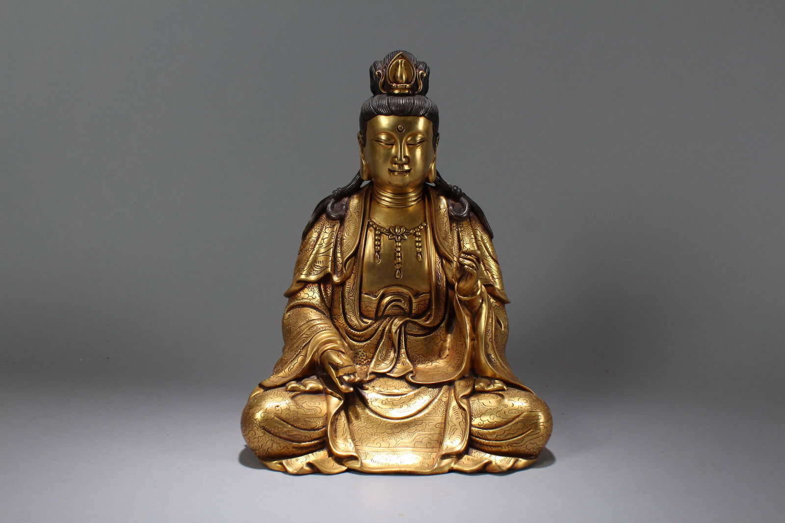 A Chinese Vividly-detailed Gilt Fortune Buddha Statue: A Chinese Vividly-detailed Gilt Fortune Buddha Statue. Height: 12 (inch). Width: 9 (inch). Length: 7 (inch)