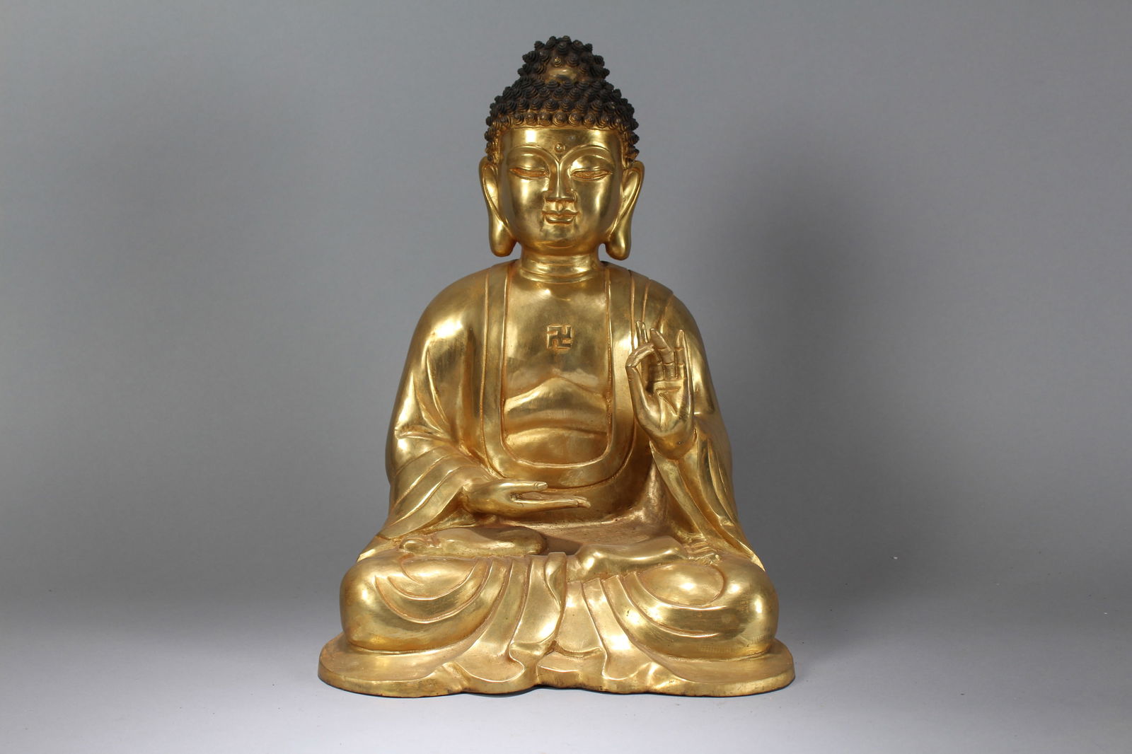 A Chinese Religious Massive Vividly-detailed Gilt Buddha Statue: A Chinese Religious Massive Vividly-detailed Gilt Buddha Statue. Height: 16.25 (inch). Width: 9 (inch). Length: 11.5 (inch).