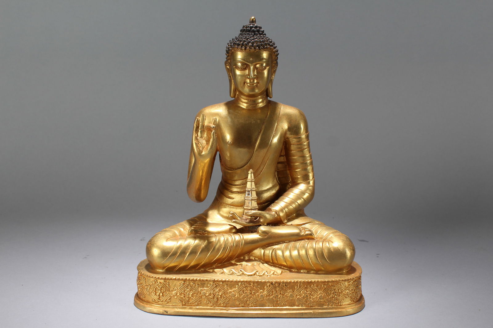 A Chinese Vividly-detailed Religious Gilt Fortune Buddha Statue: A Chinese Vividly-detailed Religious Gilt Fortune Buddha Statue. Height: 10.3 (inch). Width: 8.25 (inch)