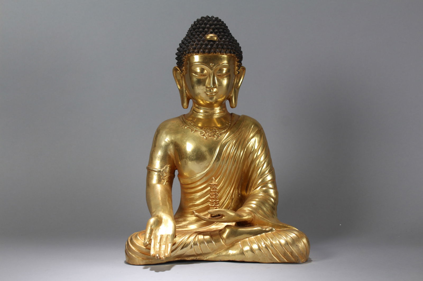 A Chinese Vividly-detailed Religious Massive Gilt Buddha Statue: A Chinese Vividly-detailed Religious Massive Gilt Buddha Statue. Height: 16.5 (inch). Width: 12 (inch). Length: 9 (inch).