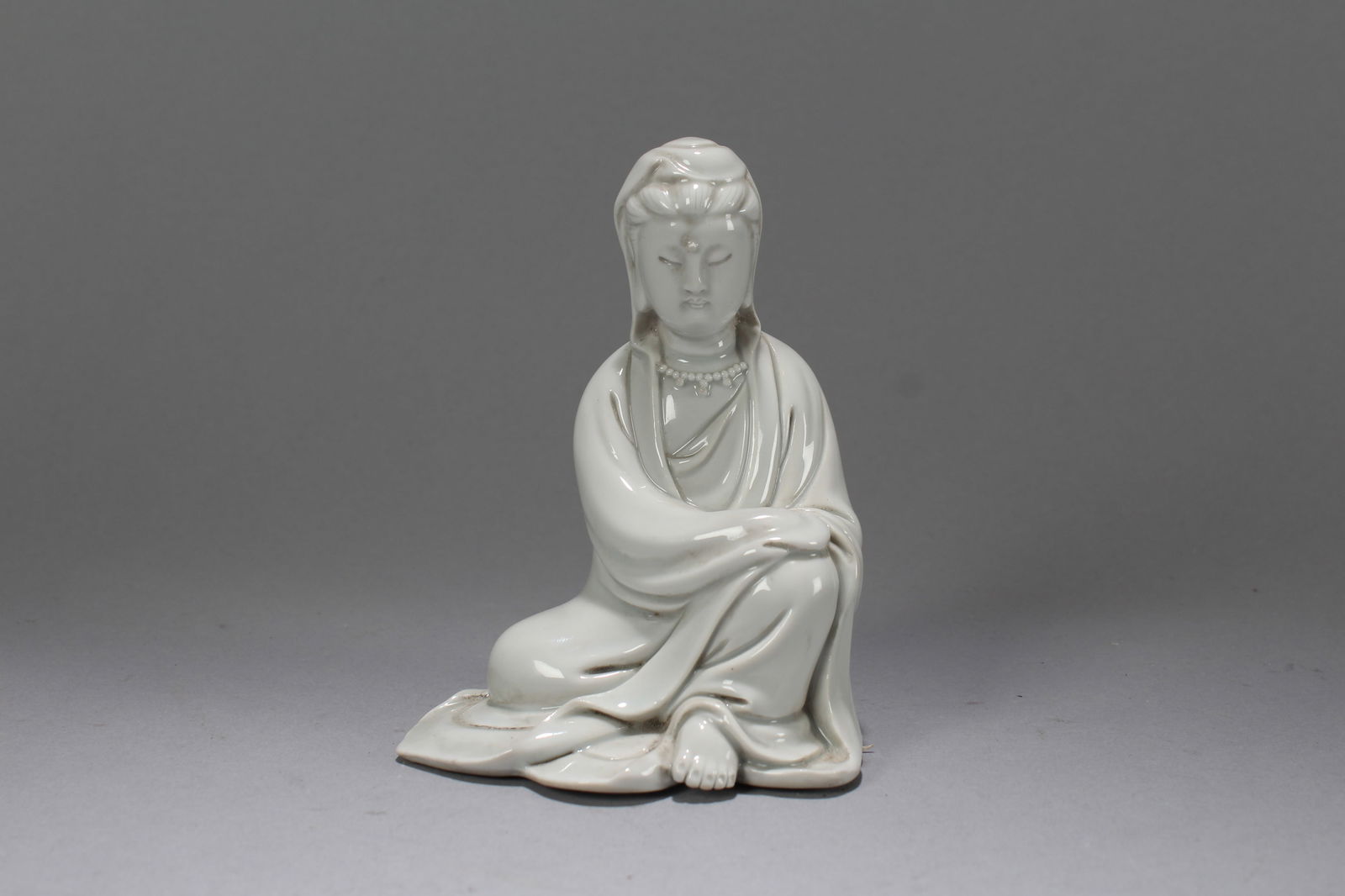 A Chinese De Blac Porcelain Fortune Guanyin Fortune Statue: A Chinese De Blac Porcelain Fortune Guanyin Fortune Statue. Height: 5.25 (inch). Width: 3.75 (inch). Length: 3 (inch)