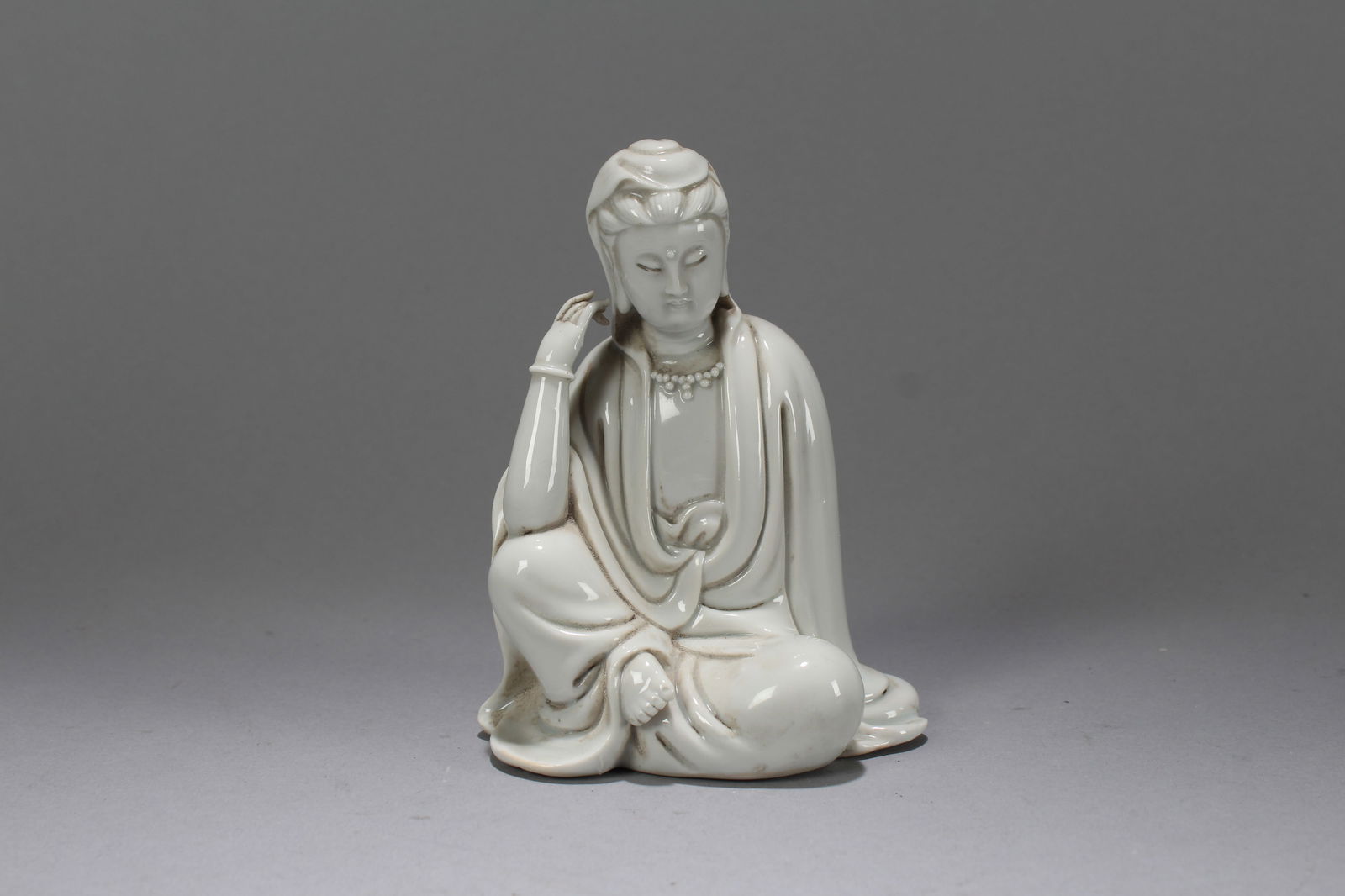 A Chinese De Blac Porcelain Fortune Guanyin Fortune Statue: A Chinese De Blac Porcelain Fortune Guanyin Fortune Statue. Height: 5.25 (inch). Width: 3.75 (inch). Length: 3 (inch)