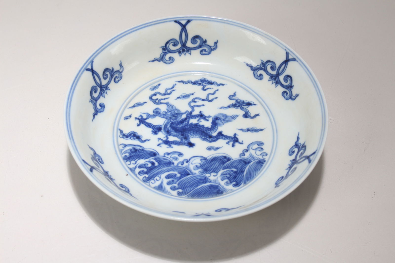 A Chinese Blue and White Porcelain Dragon-decorating Plate: A Chinese Blue and White Porcelain Dragon-decorating Plate. Height: 1.5 (inch). Opening Diameter: 6.25 (inch)