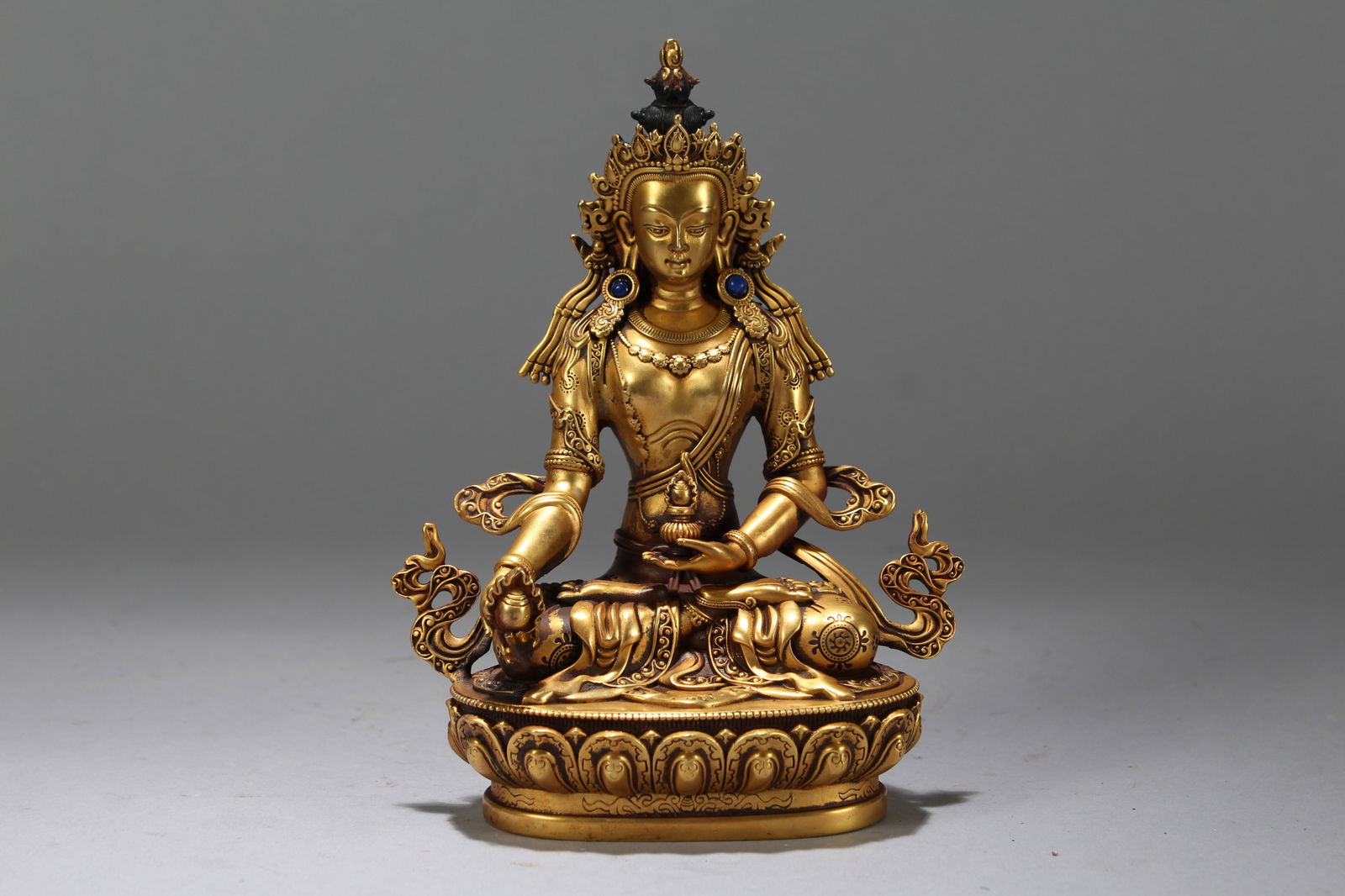 A Chinese Gilt Vividly-detailed Religious Fortune Buddha Statue: A Chinese Gilt Vividly-detailed Religious Fortune Buddha Statue. Height: 6 (inch). Width: 4.75 (inch). Length: 3 (inch).