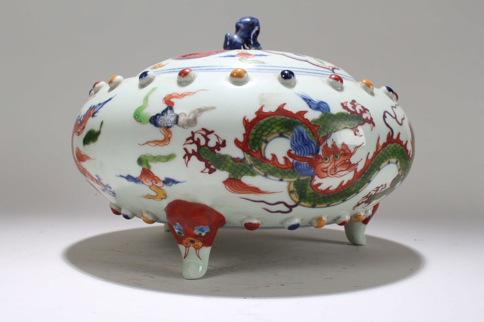 A Chinese Tri-podded Dragon-decorating Porcelain Fortune Vase: A Chinese Tri-podded Dragon-decorating Porcelain Fortune Vase . Height: 7.25 (inch). Opening Diameter: 9.5 (inch).