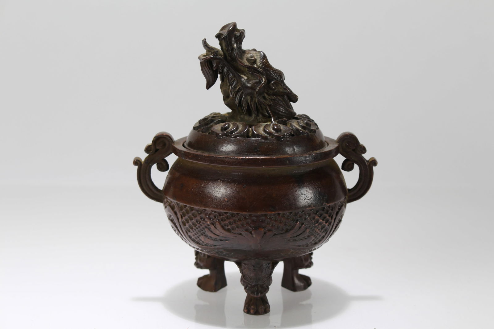 A Chinese Duo-handling Tri-podded Lidded Fortune Censer: A Chinese Duo-handling Tri-podded Lidded Fortune Censer. Height: 5 (inch). Length: 4.5 (inch).