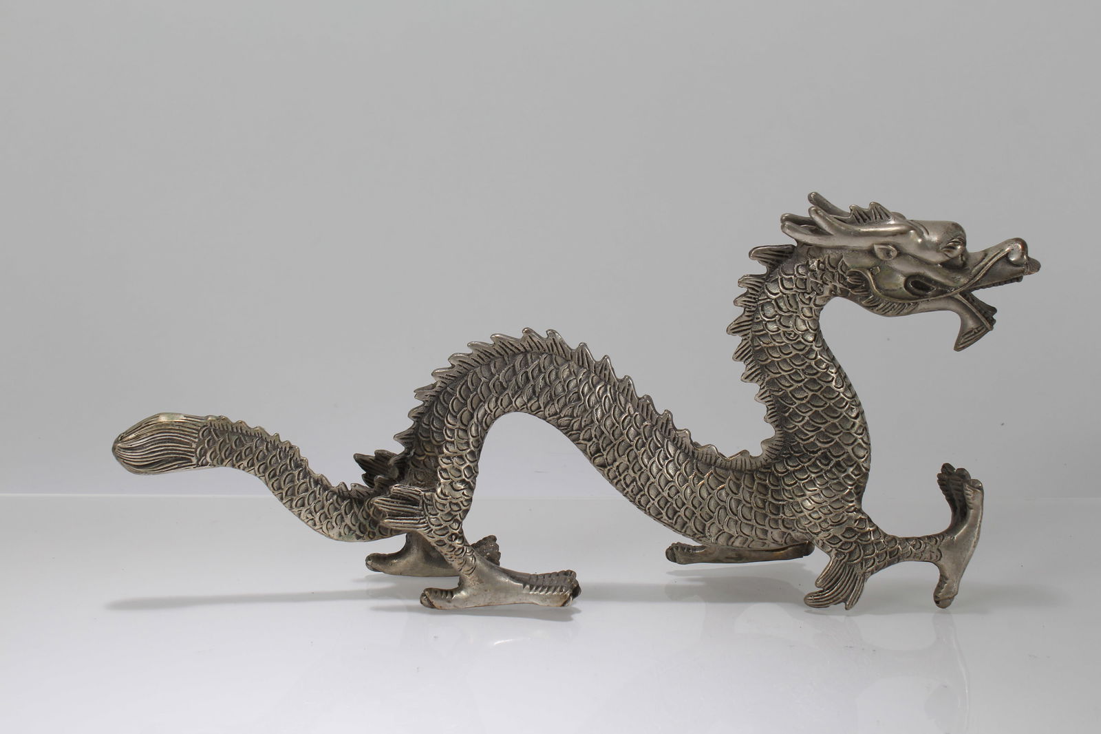 A Chinese Dragon-decorating Fortune Statue Display: A Chinese Dragon-decorating Fortune Statue Display. Height: 6 (inch). Length: 13 (inch). Width: 2 (inch).