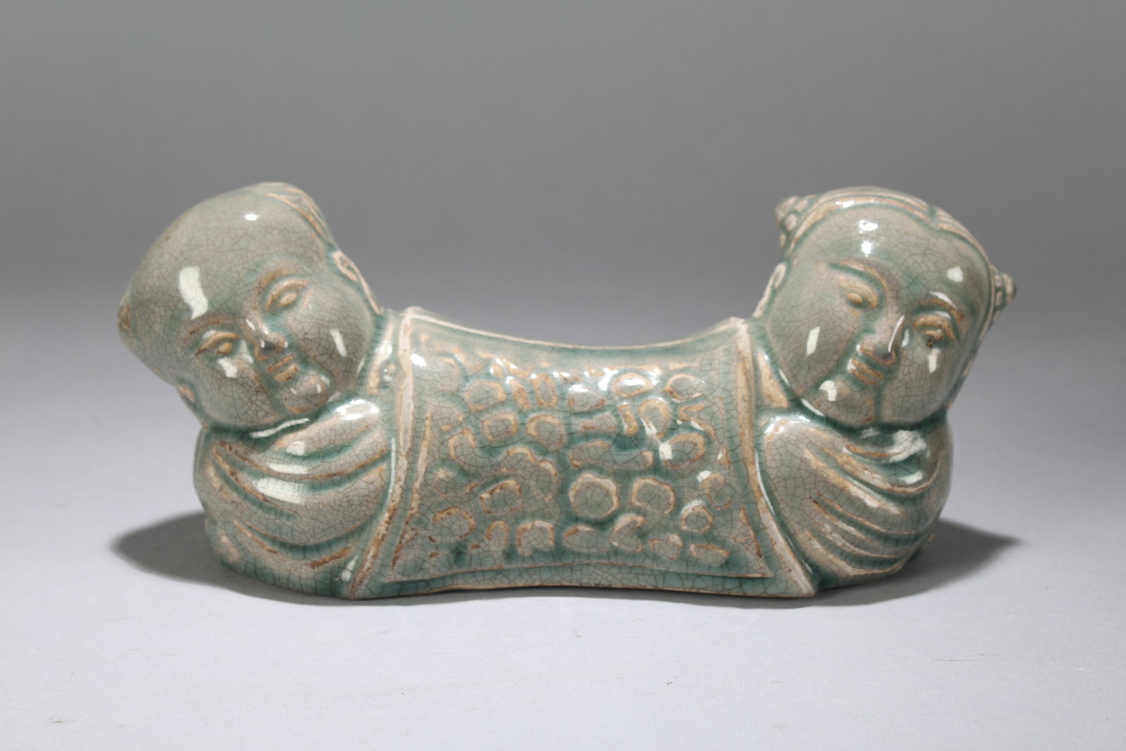 A Chinese Joyful-kid Religious Fortune Pillow Stand: A Chinese Joyful-kid Religious Fortune Pillow Stand. Height : 3.5 (inch). Width : 9 (inch). Length : 2.25 (inch).