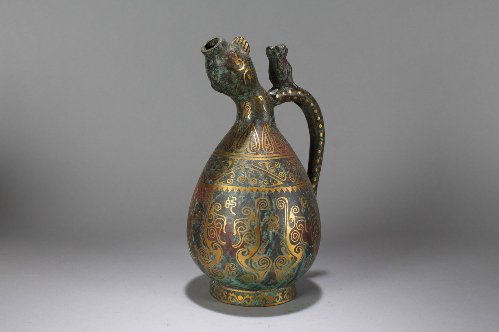 A Chinese Anicent-framing Bronze Vessel: A Chinese Anicent-framing Bronze Vessel. Height : 10.5 (inch). Width : 6.5 (inch).
