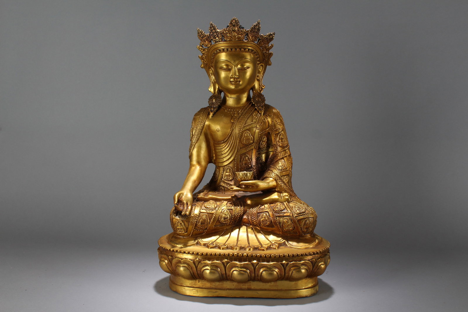 A Chinese Lotus-seated Gilt Religious Fortune Massive Buddha Statue: A Chinese Lotus-seated Gilt Religious Fortune Massive Buddha Statue. Height: 18.5 (inch). Width: 11 (inch). Length: 8 (inch).