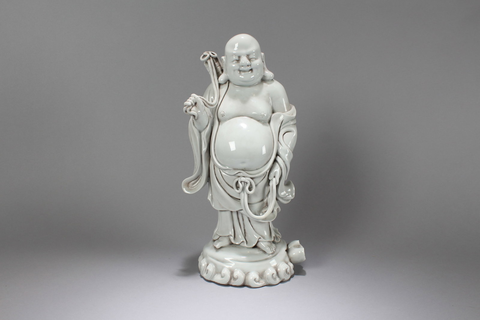 A Chinese De Blac Religious Fortune Happy-buddha Porcelain Statue: A Chinese De Blac Religious Fortune Happy-buddha Porcelain Statue. Height: 14.5 (inch). Length: 6.5 (inch)
