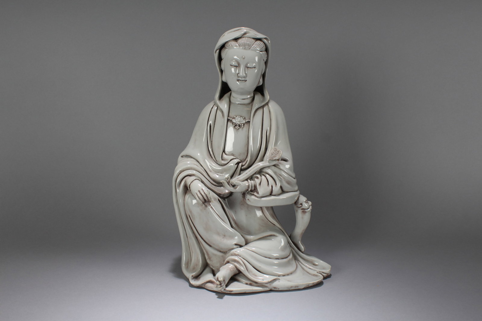 A Chinese De Blac Religious Porcelain Fortune Buddha Statue: A Chinese De Blac Religious Porcelain Fortune Buddha Statue. Height: 13.5 (inch). Width: 7.5 (inch). Length: 6 (inch).
