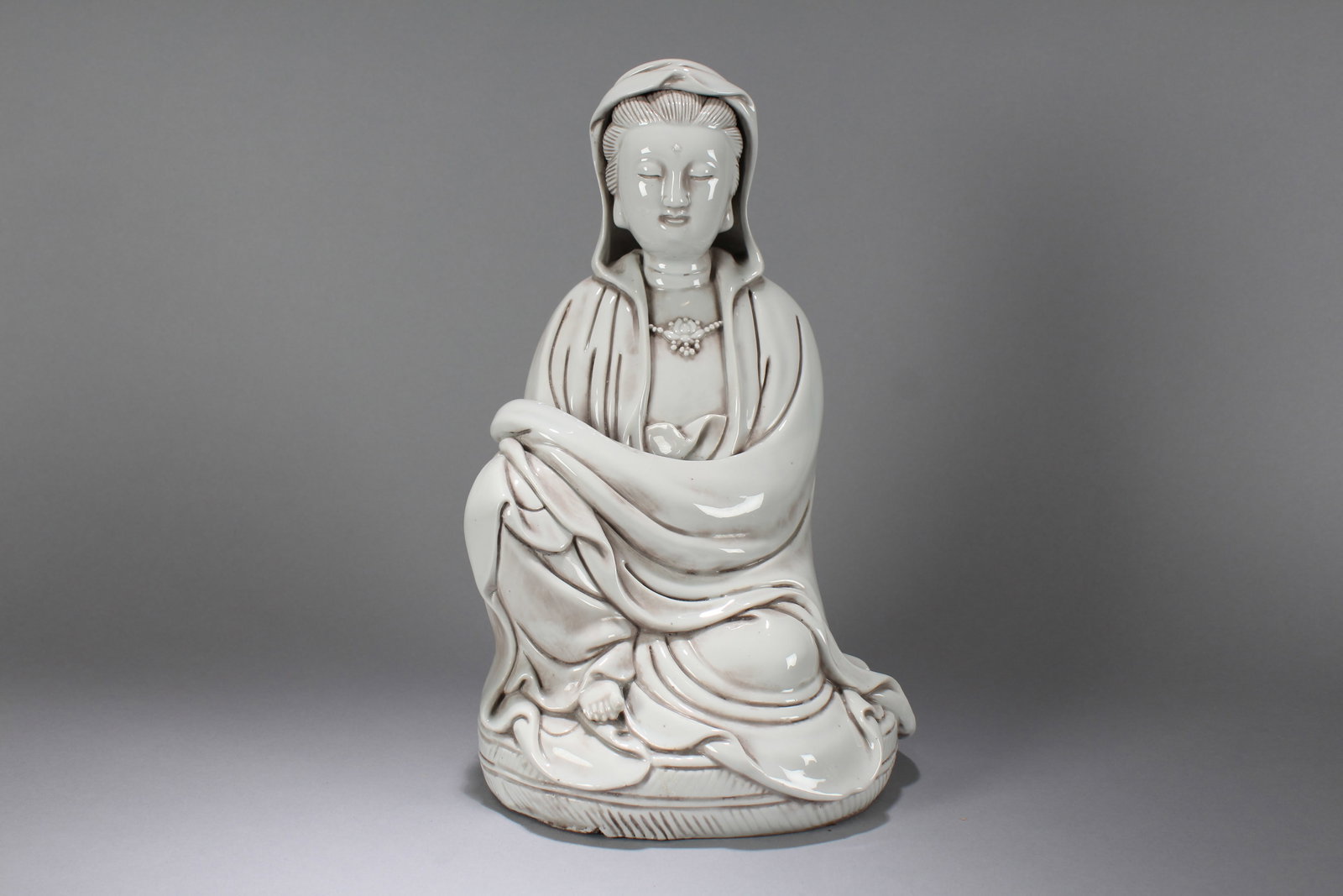 A Chinese Religious Porcelain Fortune Buddha Statue: A Chinese Religious Porcelain Fortune Buddha Statue. Height: 13 (inch). Width: 8 (inch). Length: 6 (inch).