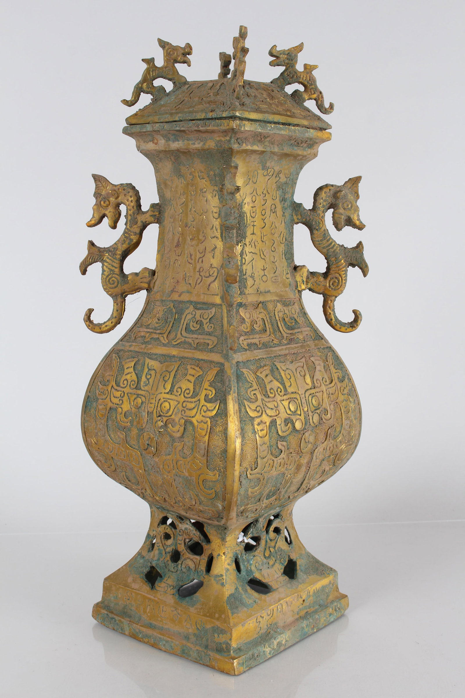 A Chinese Square-based Duo-handled Bronze Vessel: A Chinese Square-based Duo-handled Bronze Vessel. Height: 16.25 (inch).