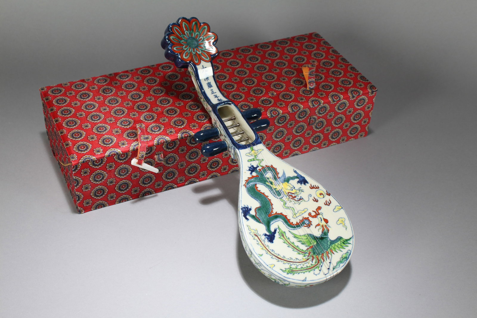 A Chinese Dragon-decorating Vividly-detailed Porcelain Fortune Lute: A Chinese Dragon-decorating Vividly-detailed Porcelain Fortune Lute. Height : 2 (inch). Width : 12.5 (inch). Length : 4 (inch).