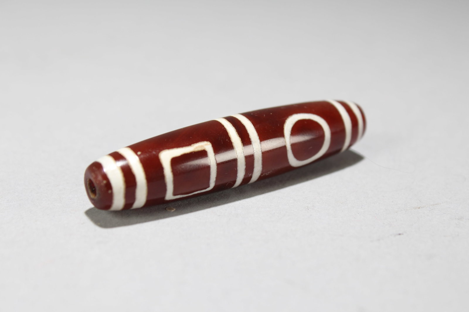 A Tibetan Fortune Bead: A Tibetan Fortune Bead. Length: 2.5 (inch). Opening Diameter: 0.5 (inch)
